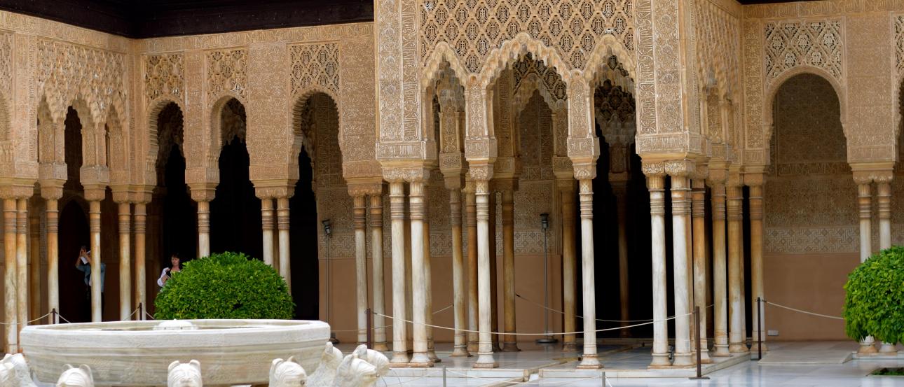 Courtyard with intricate arches and lion fountain, Alhambra, Spain. This alt text was added with Al; accuracy may vary.