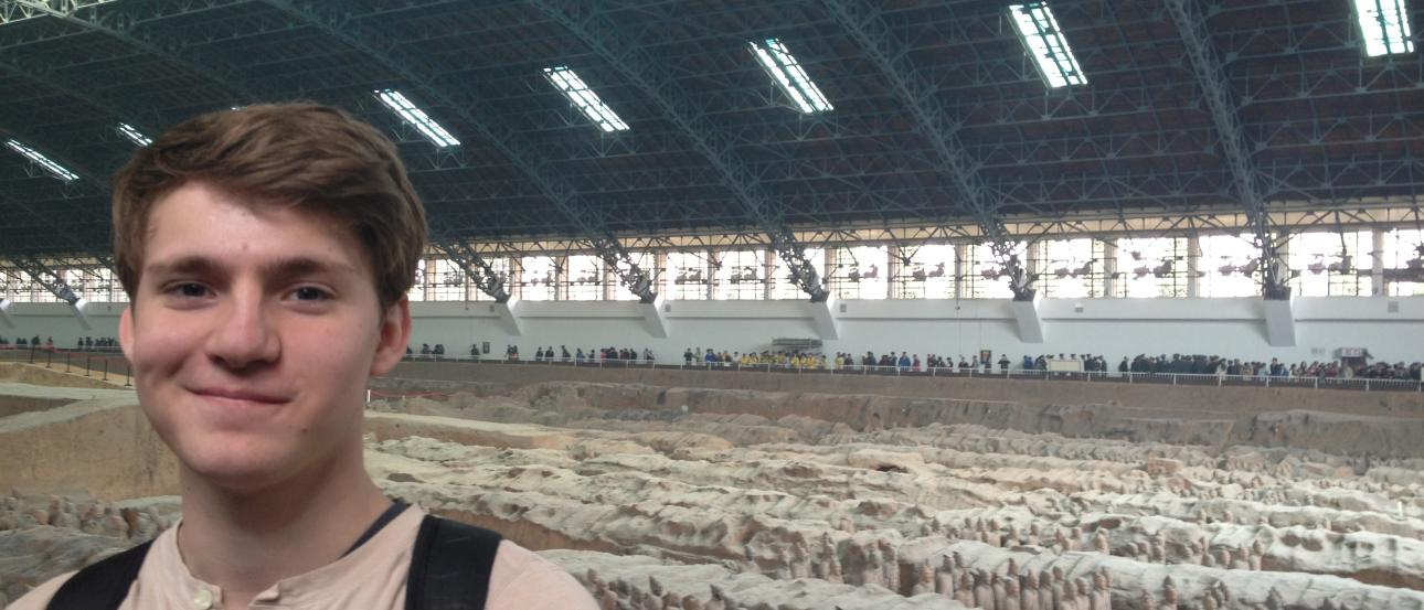 Musicians playing guitars outdoors, surrounded by people. This alt text was added with Al; accuracy may vary.