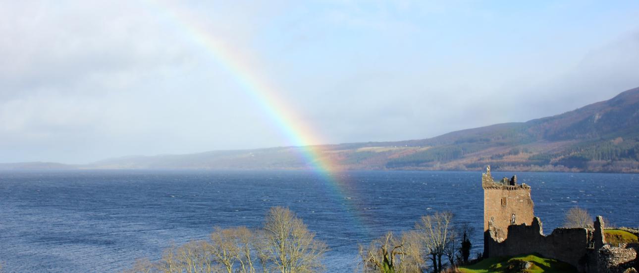 Rainbow over Loch Ness with a castle on the right. This alt text was added with Al; accuracy may vary.