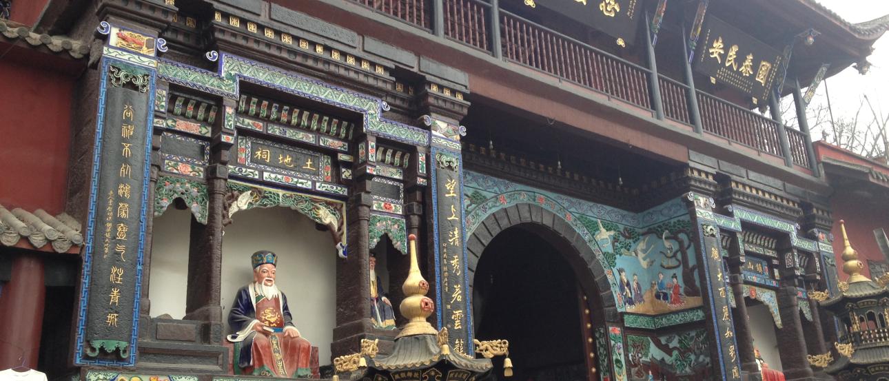 Ornate Chinese temple facade with colorful carvings and statues. This alt text was added with Al; accuracy may vary.