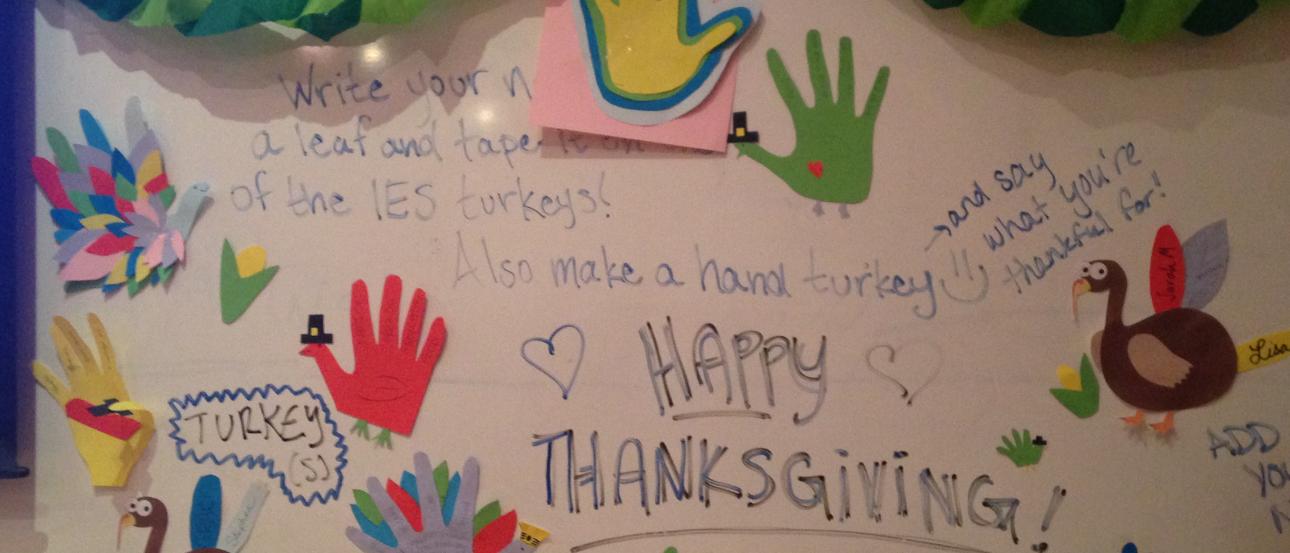 Paella with shrimp and lemon slices in a large pan. This alt text was added with Al; accuracy may vary.