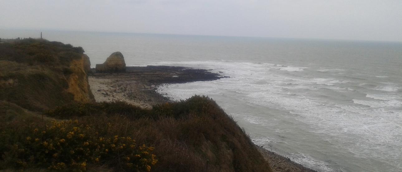 Breakfast bowls with fruit, coffee, and pastries on a wooden table.

Pillared balcony overlooking countryside with blue sky.

Cliffs overlooking a cloudy ocean view at the beach. This alt text was added with Al; accuracy may vary.