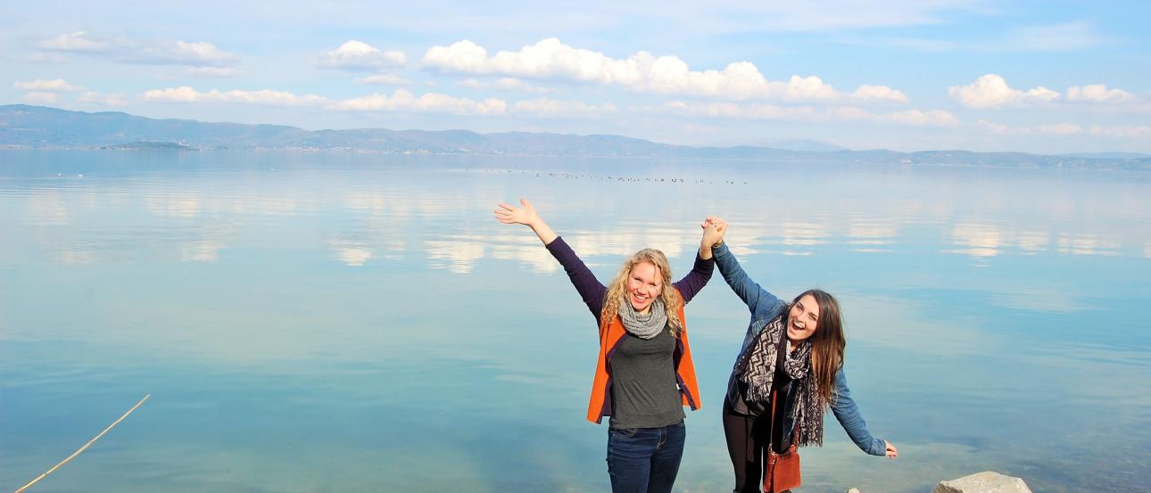 Group playing guitars outdoors, focused and engaged. This alt text was added with Al; accuracy may vary.