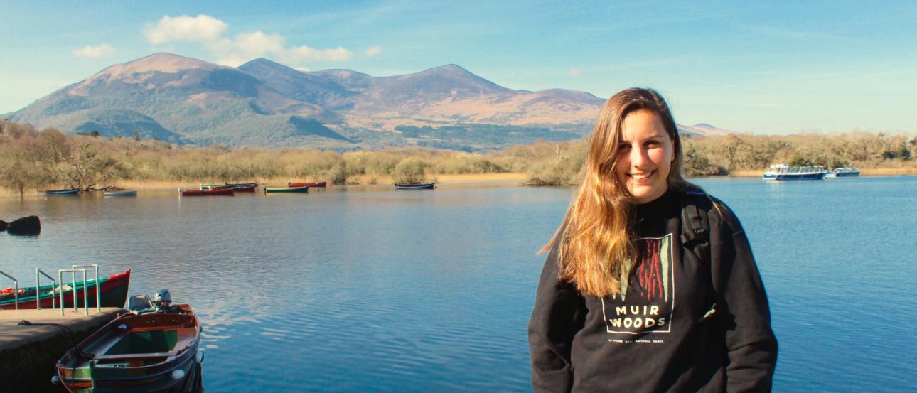 Silhouette of person with arms outstretched on a rocky beach at sunset. This alt text was added with Al; accuracy may vary.