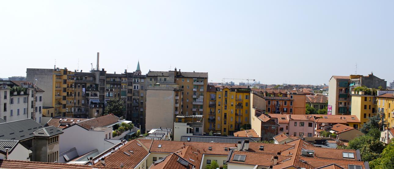 Purple bike on an Amsterdam canal bridge, with autumn trees and historic buildings. This alt text was added with Al; accuracy may vary.