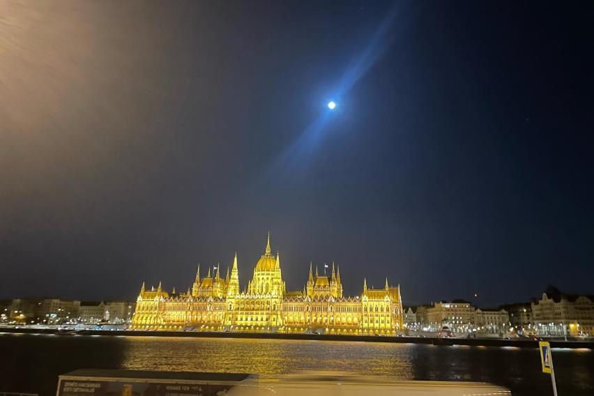 Budapest Parliament Building at night with a full moon.