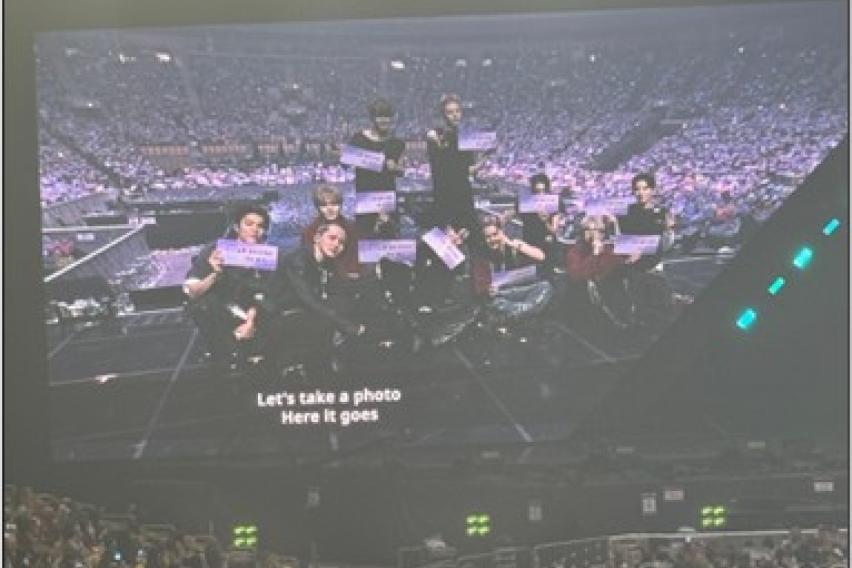 Treasure taking a picture with fans.