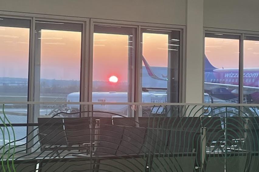 sunrise visible through the windows of airport