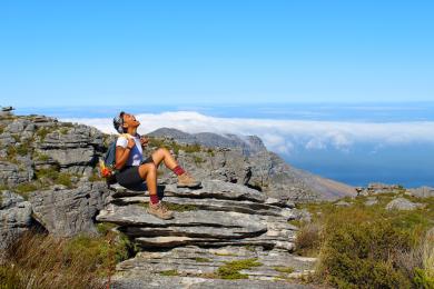 a student poses for a mountain-top photo in Cape Town