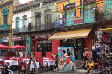 a streetside restautant among colorful buildings in La Boca, Buenos Aires
