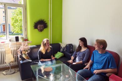 students sitting in the living space of their housing placement in Freiburg