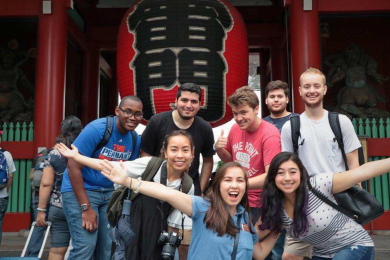 diverse students smile in front of large paper lantern in Tokyo