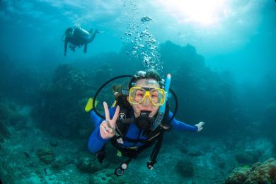 A student scuba dives in the Great Barrier Reef in Australia.