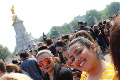 University of Texas student wearing orange shirt in crowd of people near monument