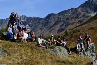 Students hike in the Alps on a sunny day with their classmates on a field trip from Freiburg, Germany.