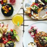 bright colorful foods on many dishes viewed from above