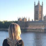 a student looks across the river Thames at British Parliament in London