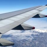 An image of a plane's wing in the sky 