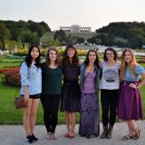 A group of students standing in front of the garden