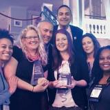 IES Abroad team smiling at a camera person (GoAbroad 2018 Innovation Awards)