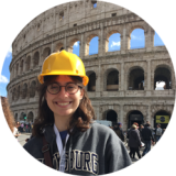A photo of a student standing near the Colosseum in Rome 