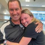 Elisabeth hugging her dad as she reunites with him at the airport. 