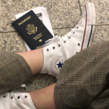 Passport on floor next to students shoe