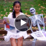 Student reading newspaper next to skeleton