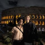 Two people in front of the Colosseum