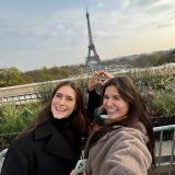 Two people posing with the Eiffel Tower in the background