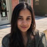 Woman smiling outdoors on a sunny day