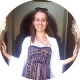 Emily Churchill smiling in front of a piece of art.