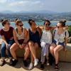 a group of students in San Sebastian, Spain laughing on a cliffside