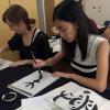 a student practices her Japanese calligraphy