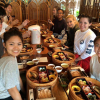 Students share a meal together in Tokyo. On the table are open bento boxes.
