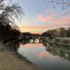 While walking alongside the Tiber River, the sunset illuminates the water in beautiful colors. 