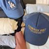 Pictures of two hats in a suitcase with packed clothes