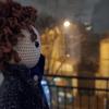 A doll resembling the iconic BBC series' "Sherlock" very own Sherlock staring out a window at the snow falling in Paris.