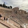 Photo of me, seen from behind, taking a picture of the roman theatre in Carthage