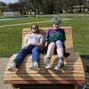 Two friends share a large bench in Salzburg, Austria.