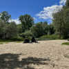 Friends sitting at the river on a sunny day in Salamanca