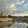 A view of Rome's historical buildings against the blue Tiber River