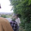 Three friends hike down Kahlenberg as the sun sets over the city.