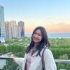 Eileen Li smiling in front of a skyline.
