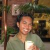 Sasa Ramos smiling and holding a cup of coffee.