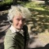 Grace Merryman smiling in front of greenery.
