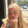 Hannah Grohman posing with a drink in her hands.