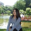 Stephanie Sanchez smiling in front of water and trees.