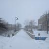 A bridge at Lawrence University in Appleton in dim light, covered in snow.