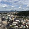 An aerial view of Salzburg, taken from the fortress. There are many houses and buildings below, including a cathedral.